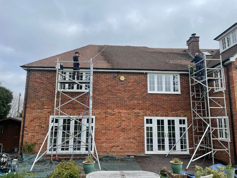 Roof cleaning carried out safely from scaffold towers by The Roof Moss Cleaners in Virginia Water